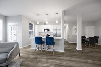 A modern kitchen with a dining table and chairs.